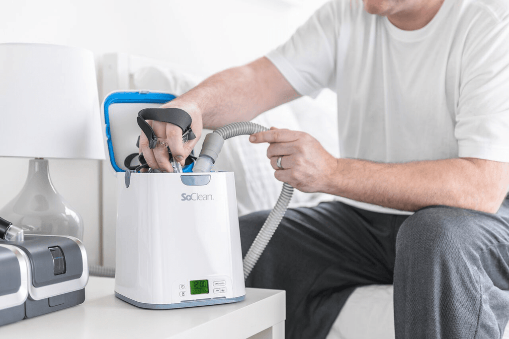 SoClean 2 CPAP Cleaner and Sanitizer open with man taking mask out